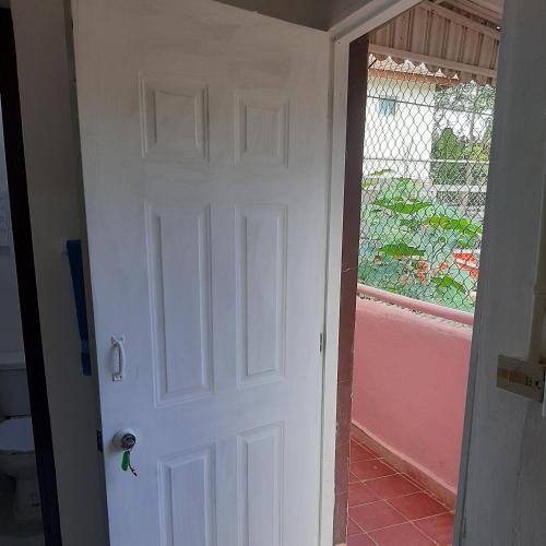 a white door in a room with a window at B&B KeisyAlba Punta Rucia in Punta Rucia