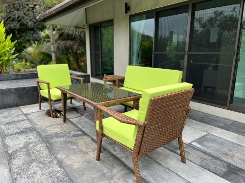 two chairs and a table on a patio at The Height Khaoyai Resort in Ban Huai Sok Noi
