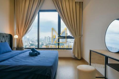a bedroom with a blue bed and a large window at Maxhome Plus at Lucentia Bukit Bintang City centre KL in Kuala Lumpur