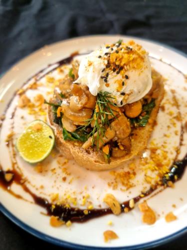 a plate with a sandwich with a fried egg on it at Khamara Nusa Penida in Nusa Penida