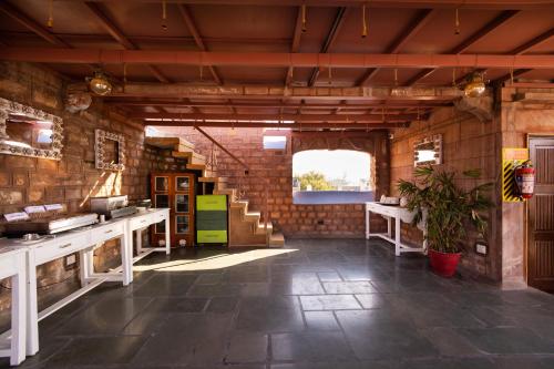 a large room with a brick wall and a staircase at Amritara Manak Haveli, Jodhpur in Jodhpur