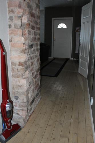 a living room with a brick wall and a red fireplace at Vintergatans Rum in Insjön
