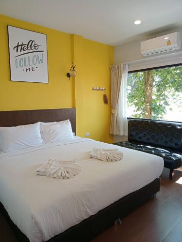 a bedroom with a large white bed and a window at Blue Orchid Beach Krabi - SHA Certified in Ao Nam Mao