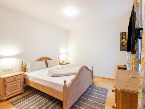 a small bedroom with a bed and a table at Property in Kaltenbach in Kaltenbach