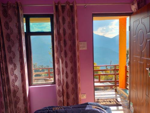 a room with two windows with a view of a balcony at Pandava's Cafe & Stay in Chopta