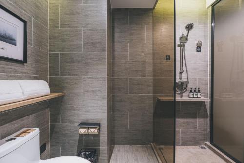 a bathroom with a shower and a toilet at Atour Hotel East Nanjing Road Near The Bund in Shanghai