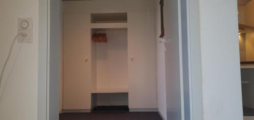a walk in closet with white walls and a door at Ferienwohnung am Bodensee mit Seesicht und Terrasse in Rorschacherberg