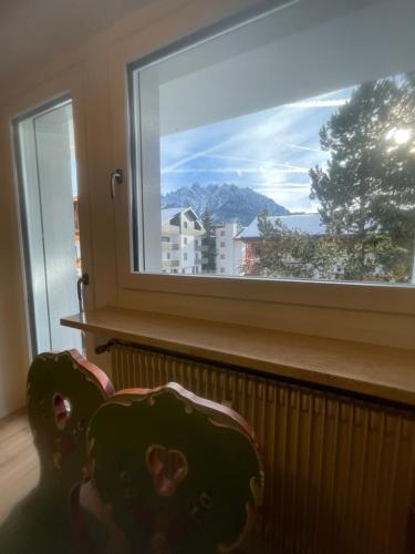 a window with a view of a city at Appartamento a Dobbiaco nel cuore delle Dolomiti in Dobbiaco
