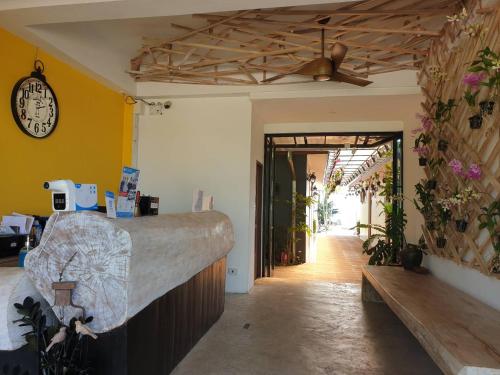 a room with a counter and a clock on the wall at Blue Orchid Beach Krabi - SHA Certified in Ao Nam Mao