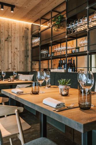 a table in a restaurant with wine glasses on it at Hotel Fiescherblick in Grindelwald