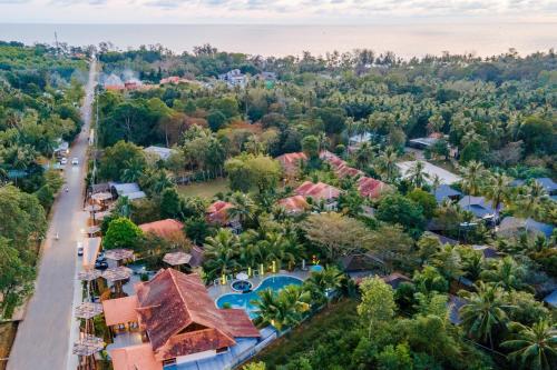 an aerial view of a resort with a pool and trees at Elwood Premier Resort Phu Quoc in Phú Quốc