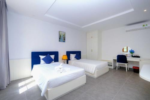 Postel nebo postele na pokoji v ubytování Rose Hotel Phú Quốc