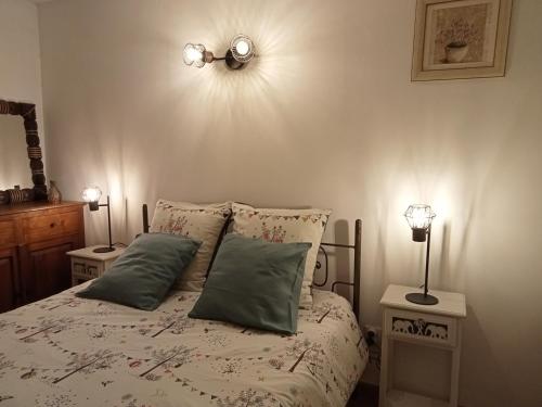 a bedroom with a bed with two lamps on it at Appartement Croisette in Sainte-Maxime