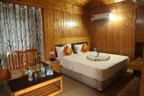 a bedroom with a bed in a room with wooden walls at Sambodhi Retreat in Dhanbād