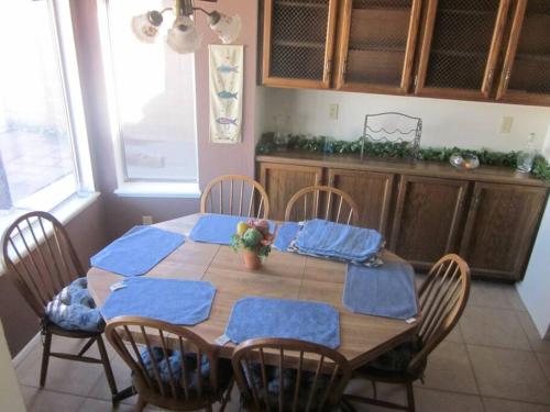 a dining room table with blue napkins on it at 4 Bedroom Home-Casino-State Farm Stadium only 2 Miles in Glendale
