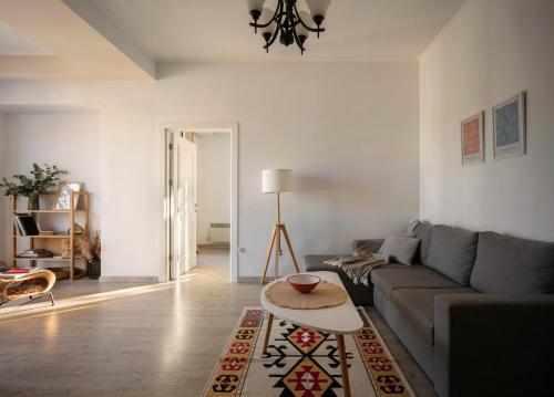 a living room with a couch and a table at Modern apartment In Dilijan with great view in Dilijan