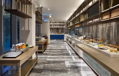 a restaurant with a buffet line with food at Wanda Vista Istanbul in Istanbul