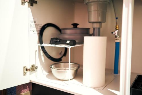 a kitchen shelf with a mixer and a bowl at Rakuten STAY Kokura Station Standard Twin Room in Kitakyushu