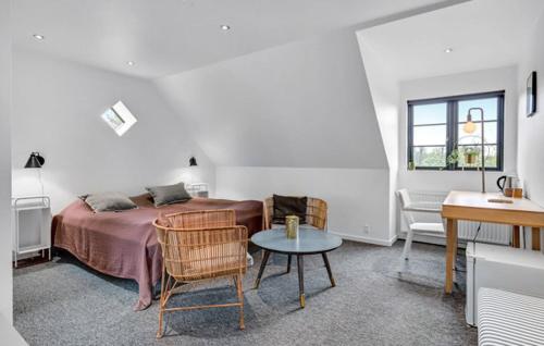 a bedroom with a bed and a table and a desk at Hedegaarden in Engesvang