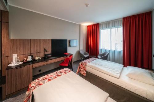 Postel nebo postele na pokoji v ubytování HP Park Plaza