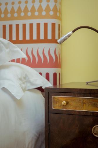 a lamp on a nightstand next to a bed at Bahia Vik in José Ignacio