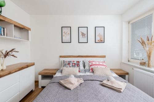 una camera da letto con un letto con cuscini sopra di Apartament z parkingiem Zakopane a Zakopane