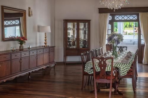 a dining room with a table and chairs and a chandelier at W15 Lake Gregory in Nuwara Eliya