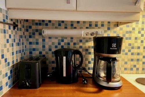 a kitchen counter with a coffee maker and a blender at Huoneisto Jalkarannassa in Lahti