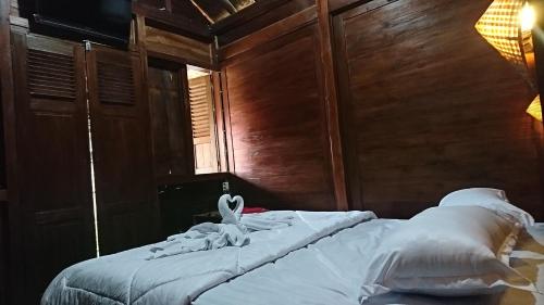 a bed with a white towel on it in a room at Wisma Andany in Jepara