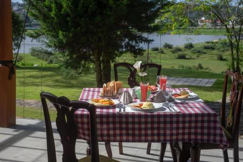 a table with plates of food on top at W15 Lake Gregory in Nuwara Eliya