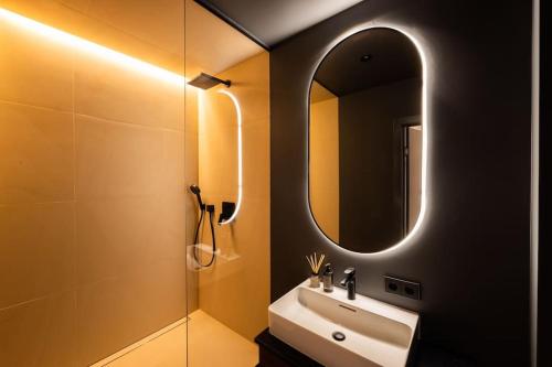 a bathroom with a sink and a mirror at Kalnu dzīvoklis (The hill condo) in Cēsis