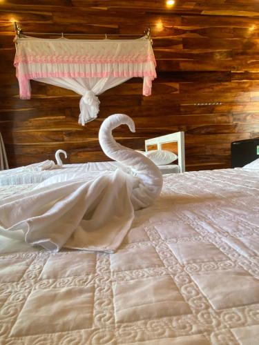 a bedroom with a bed with a snake on it at FOREST BREATH ECO-LODGE in Tân Phú