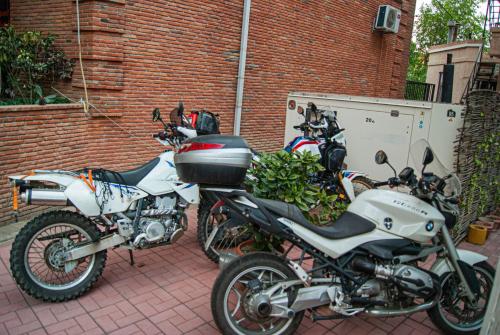a group of motorcycles parked next to a brick building at Sani Apart Hotel in Tbilisi City