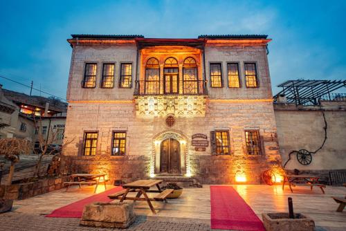 a large brick building with lights on at Old Greek House in Urgup