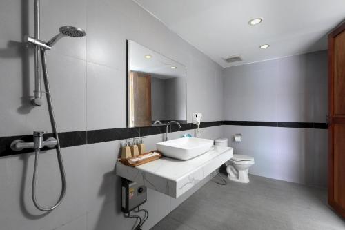 a bathroom with a white sink and a shower at Daydream villa resort in Patong Beach