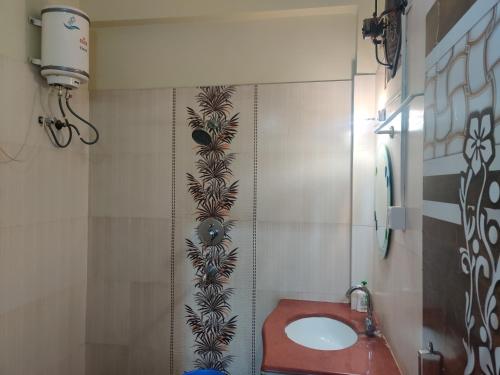 a bathroom with a red toilet and a sink at Om Paradise in Ujjain