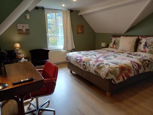 a bedroom with a bed and a desk and a chair at B&B Windsor in Waulsort