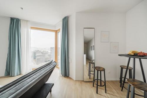 a living room with a couch and a table at City Sky Studio mit Balkon Vienna in Vienna