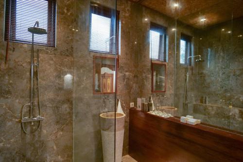 a large bathroom with two sinks and a shower at Gayatri in Ubud
