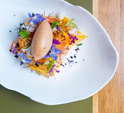 a white plate with food on a table at Auberge Pom'Poire in Azay-le-Rideau
