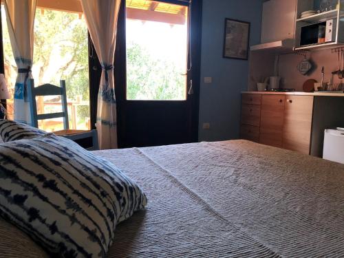 a bedroom with a large bed and a window at Amalfatah in Teulada