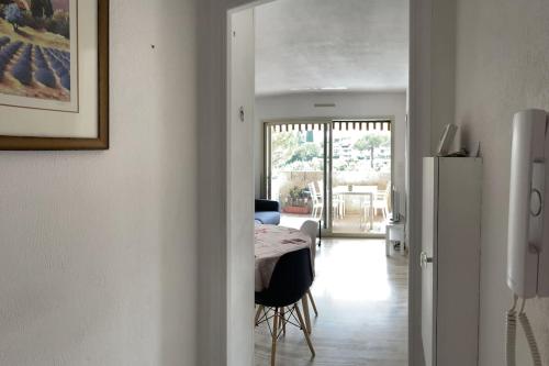 a dining room with a table and a refrigerator at Appartement 2 pièces 6mn à pied du centre in Vence