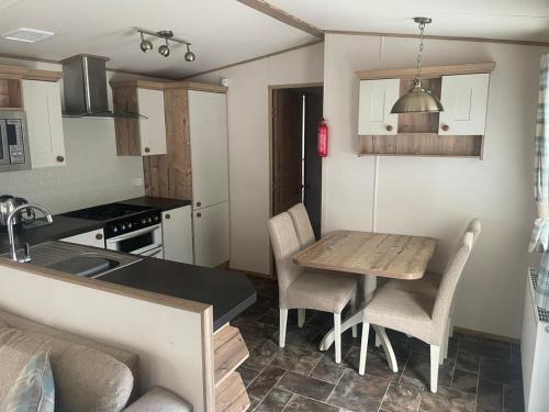 a kitchen with a table and chairs in a kitchen at Luxury 6 Berth Caravan, Marton Mere in Blackpool