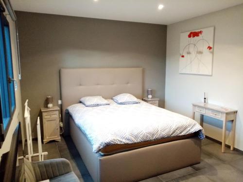 a bedroom with a bed and two night stands at Un air de campagne in Montauban