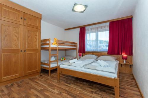 a bedroom with two beds and a bunk bed at Appartements Schmidsendl in Lofer
