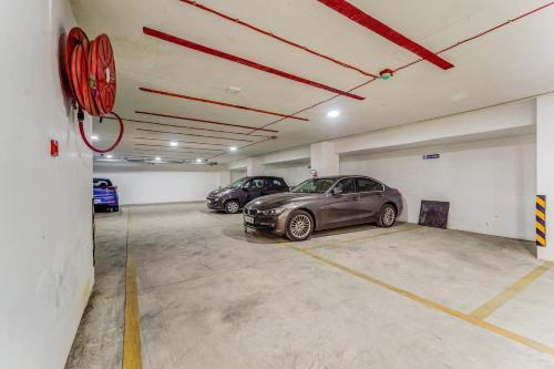 a garage with two cars parked in it at UPAR Hotels - T Nagar in Chennai