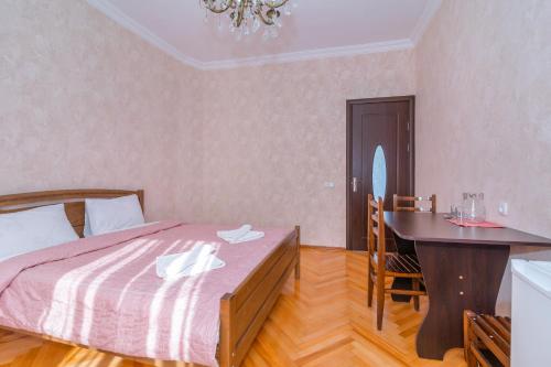 a bedroom with a bed and a table and a desk at Gogichas tower in Borjomi