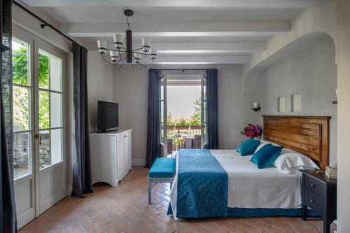 a bedroom with a large bed with blue pillows at Park Hotel Villa Belvedere in Cannobio
