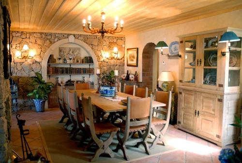 a dining room with a wooden table and chairs at Casal Santo Antonio in Sintra