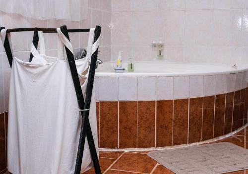 a bathroom with a bath tub and a sink at Hadassa Guest House in Burgersfort